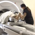 Jim Kurtz enters the MRI for his focused ultrasound treatment for essential tumor. Kurtz no longer has hand tremors that had severely limited his left-hand-use. 