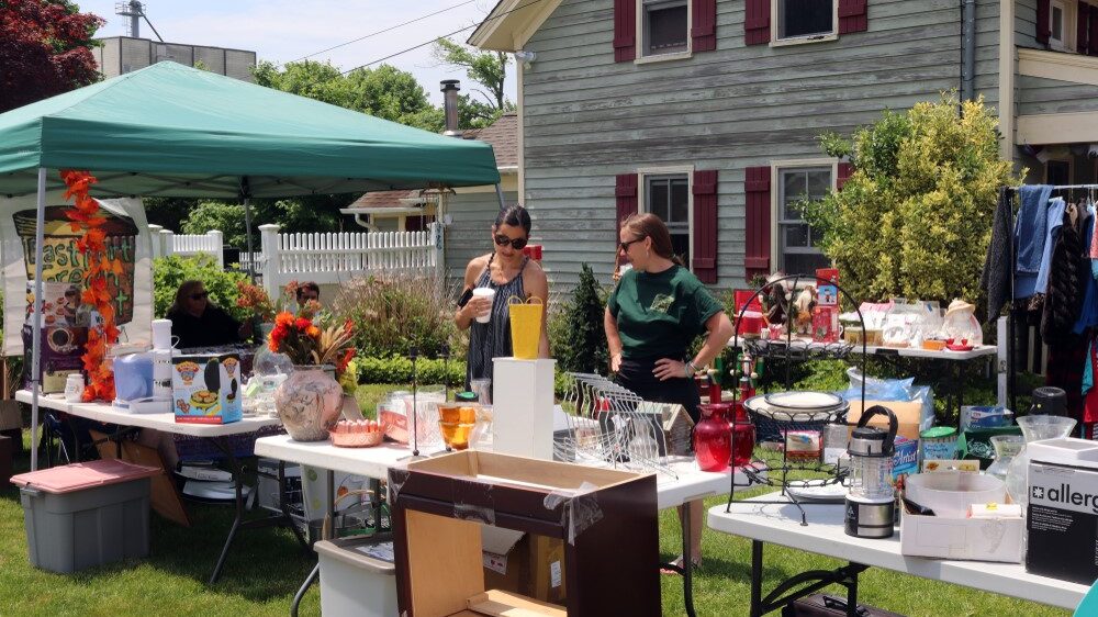 garage sale of two ladies standing outside...