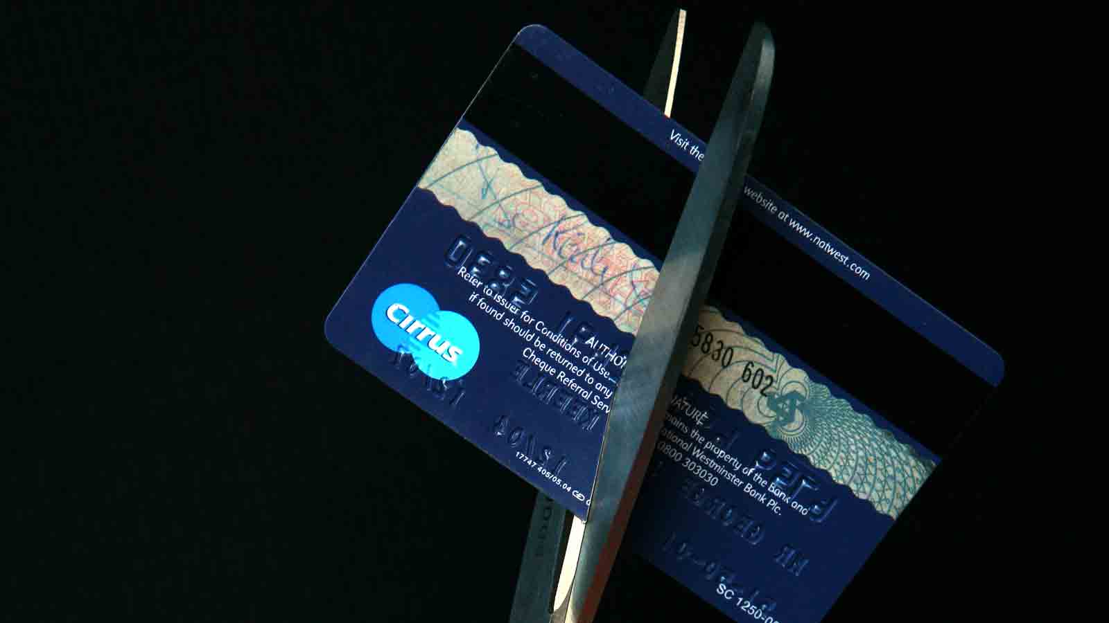 scissors cutting credit card...