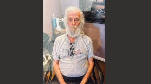 Man with long gray hair and beard...