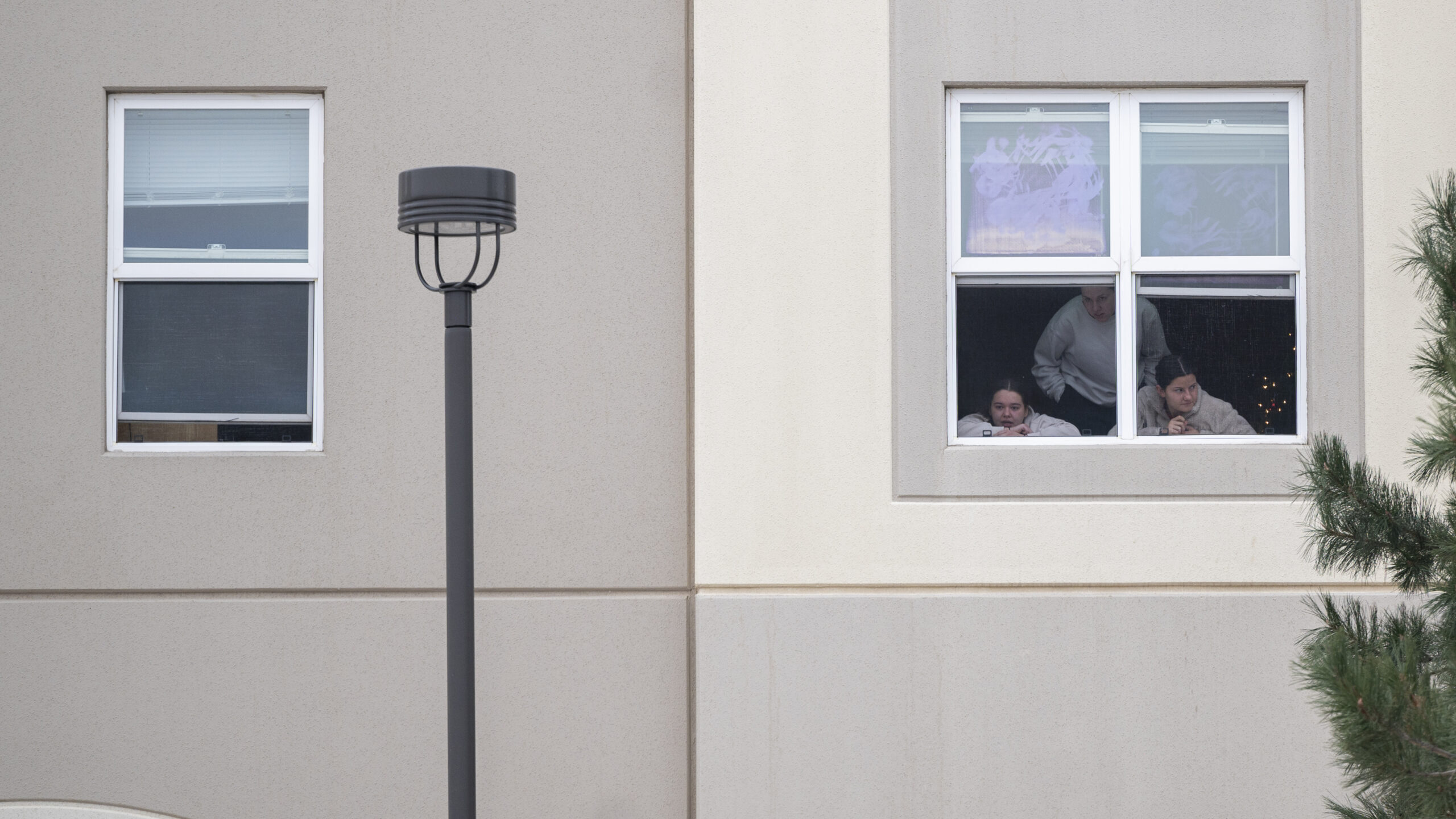 Students look outside their dorm window in the Village at Alpine Valley housing, Friday, Feb. 16, 2...