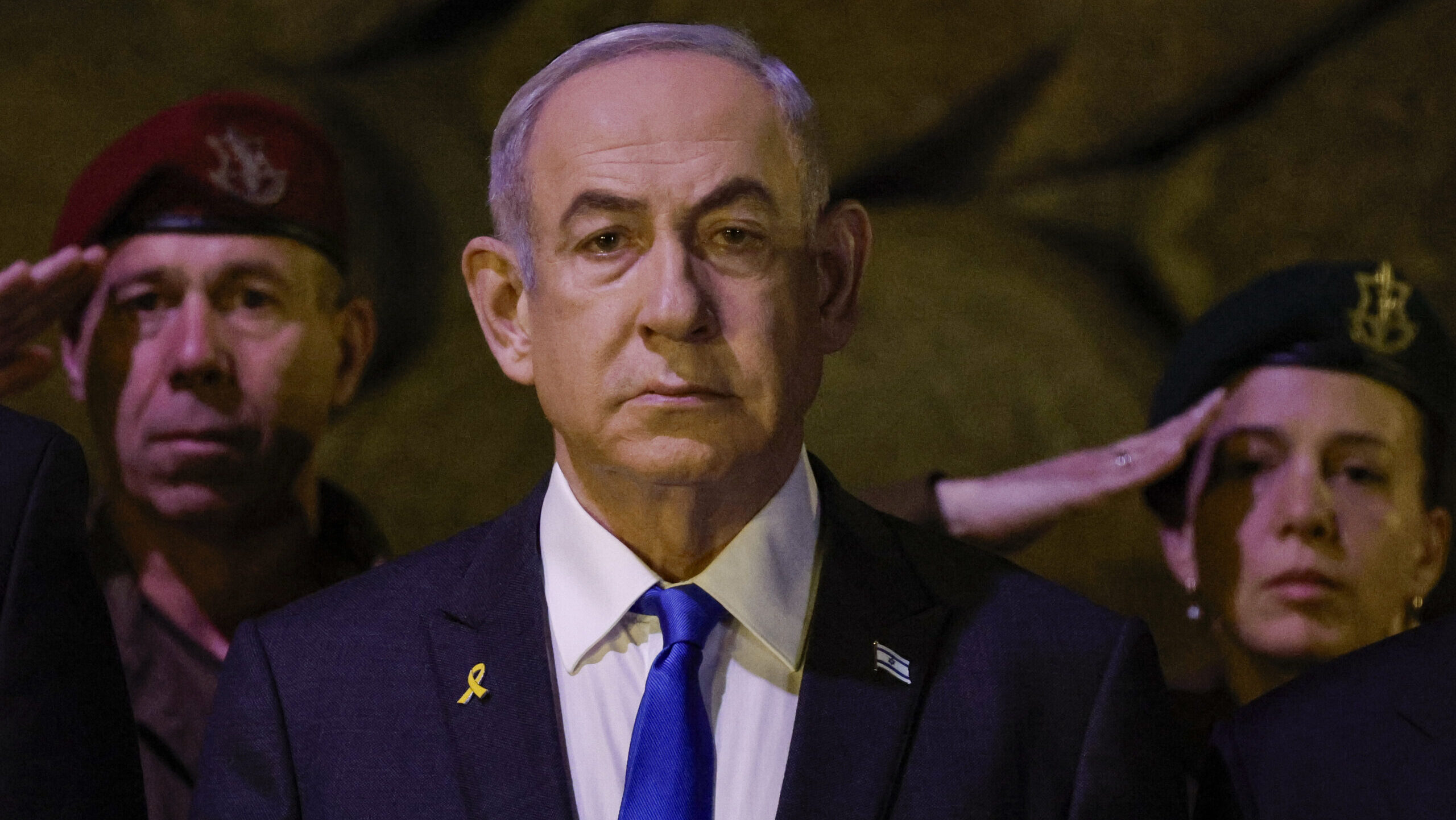 Israeli Prime Minister Benjamin Netanyahu, front, attends a wreath-laying ceremony marking Holocaus...
