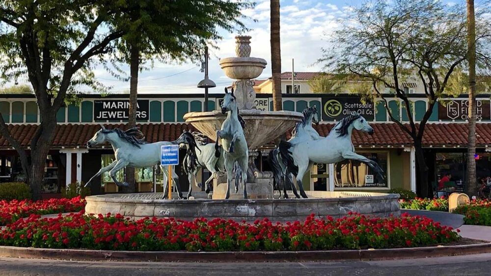 A fountain with horse sculptures is seen in Old Town Scottsdale. The city adopted a new budget for ...