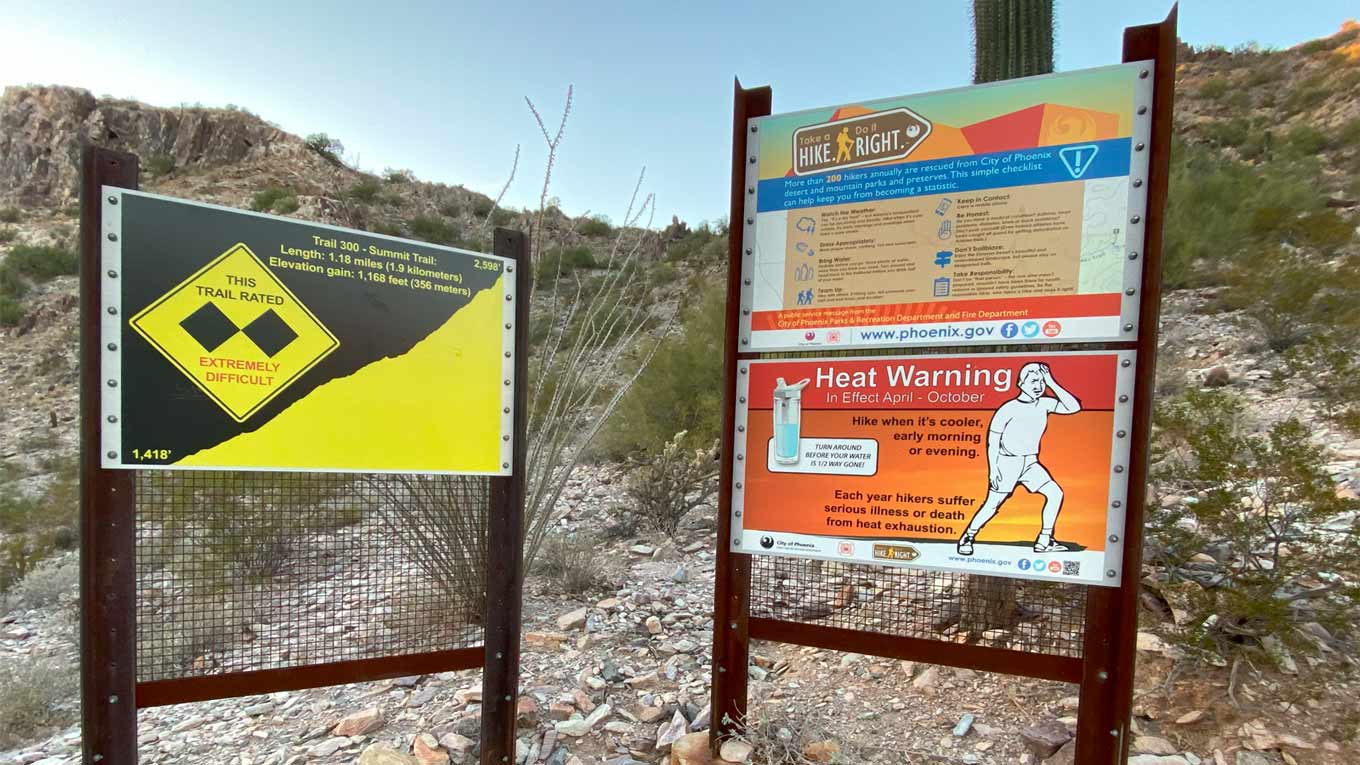 Signs warn about heat and difficulty at the Summit Trail of Piestewa Peak in Phoenix. The Valley we...