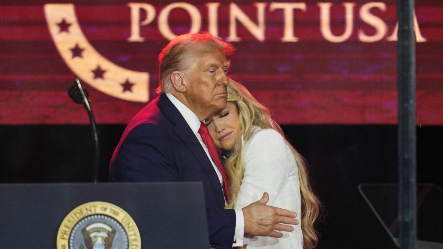 President Donald Trump embraces Erika Kirk at a memorial for conservative activist Charlie Kirk, Su...