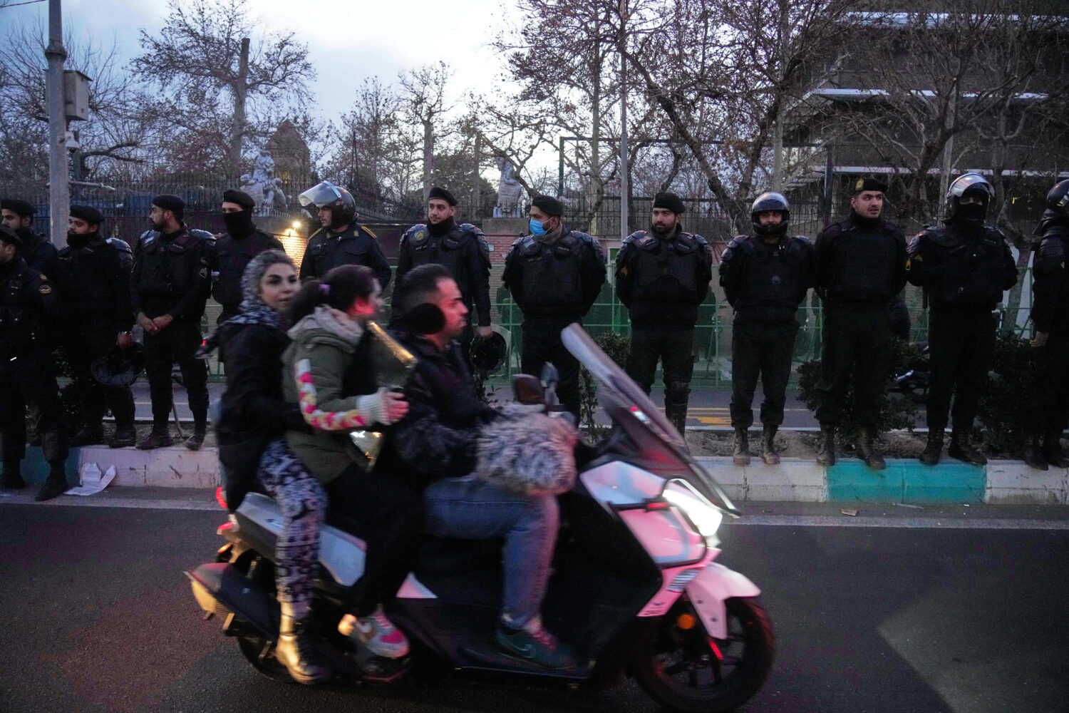 Policemen protect the British Embassy during a protest by hardline supporters of the Iranian govern...