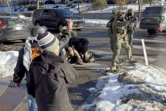 This image taken from video by Max Shapiro shows Alex Pretti, center left, scuffling with federal i...