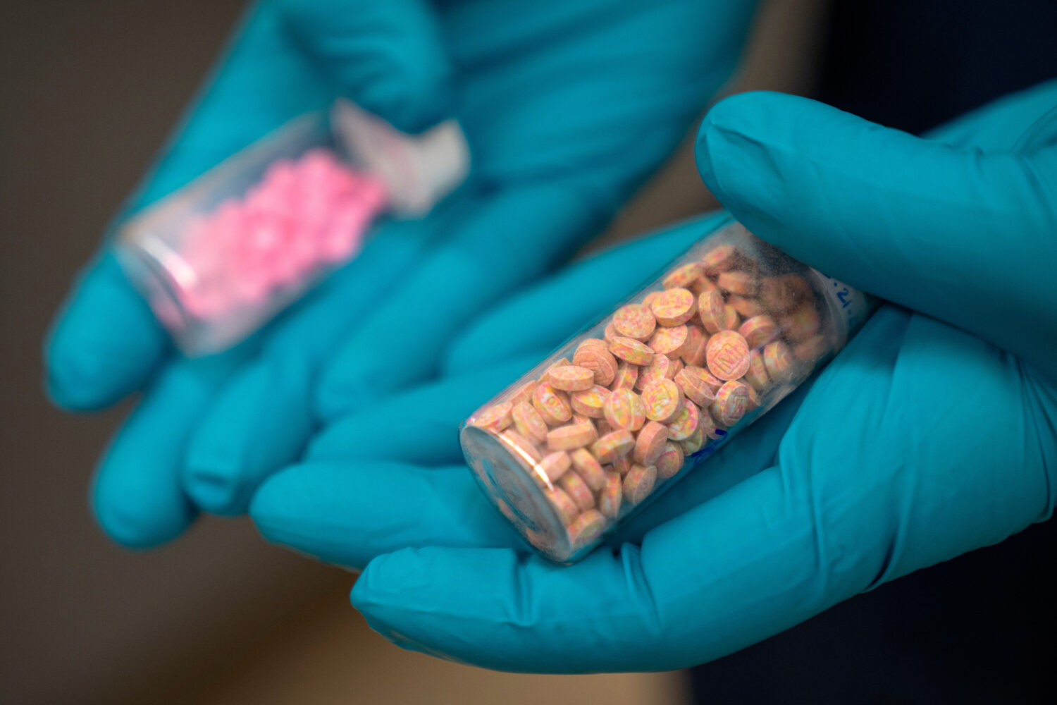 FILE - Jonathan Dumke, a senior forensic chemist with the Drug Enforcement Administration, holds vi...