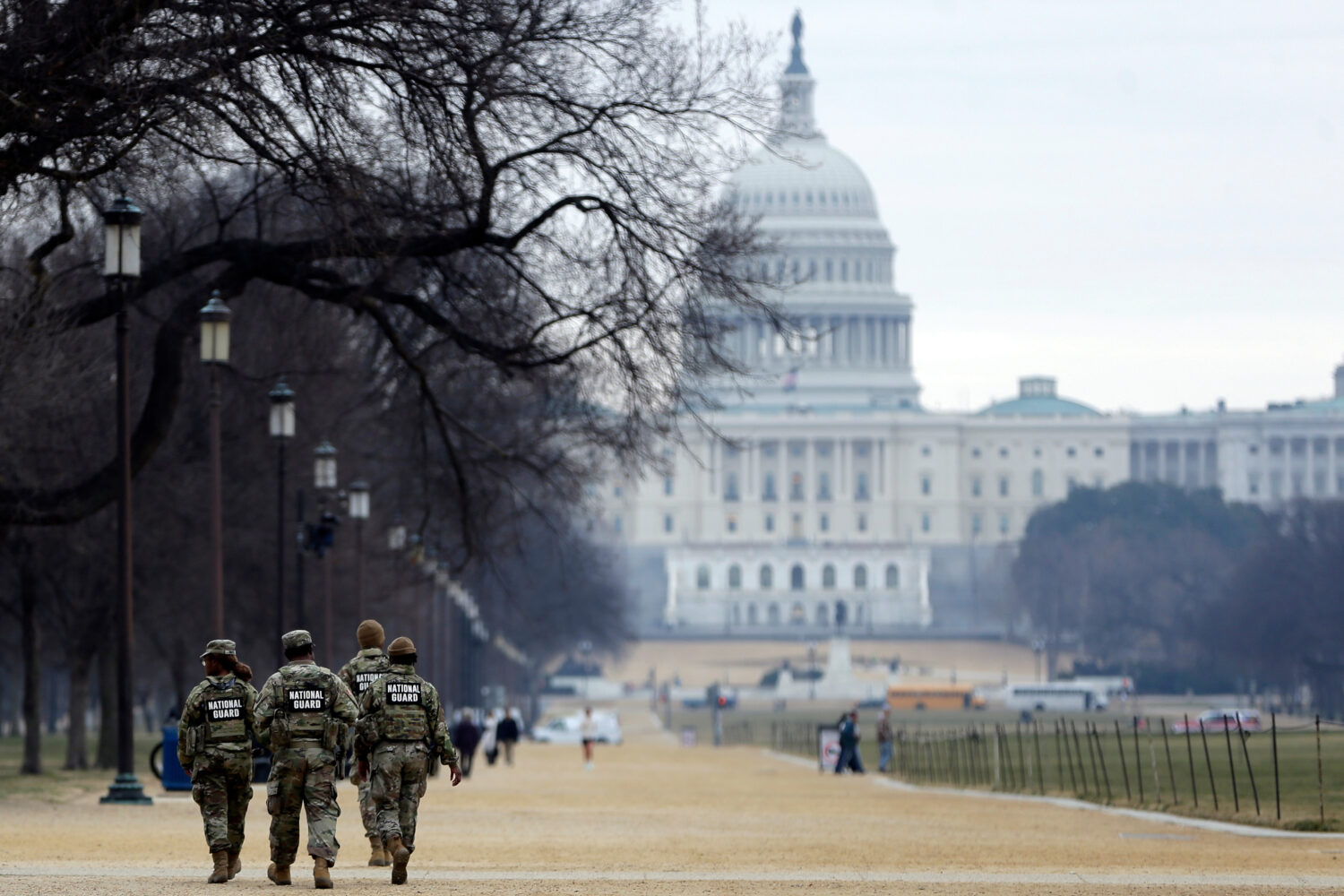 National Guard patrol the Washington Mall, with the U.S. Capitol in the background, Friday, Jan. 9,...