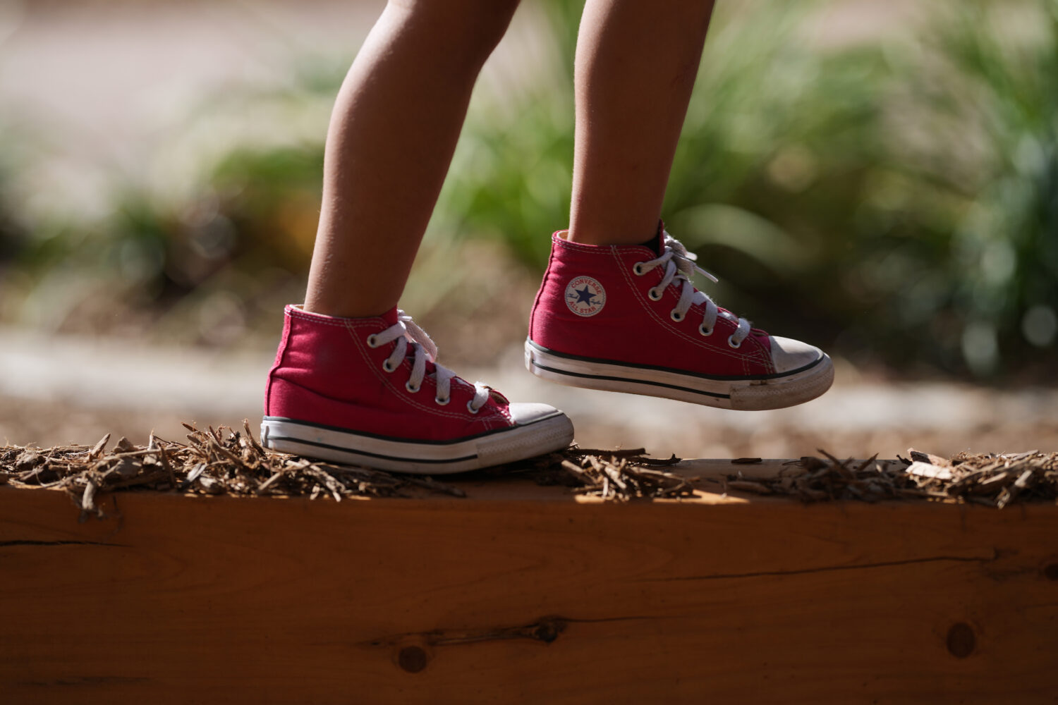 A Pre-K 4 SA student walks a beam on the playground, Oct. 9, 2025, in San Antonio. (AP Photo/Eric G...