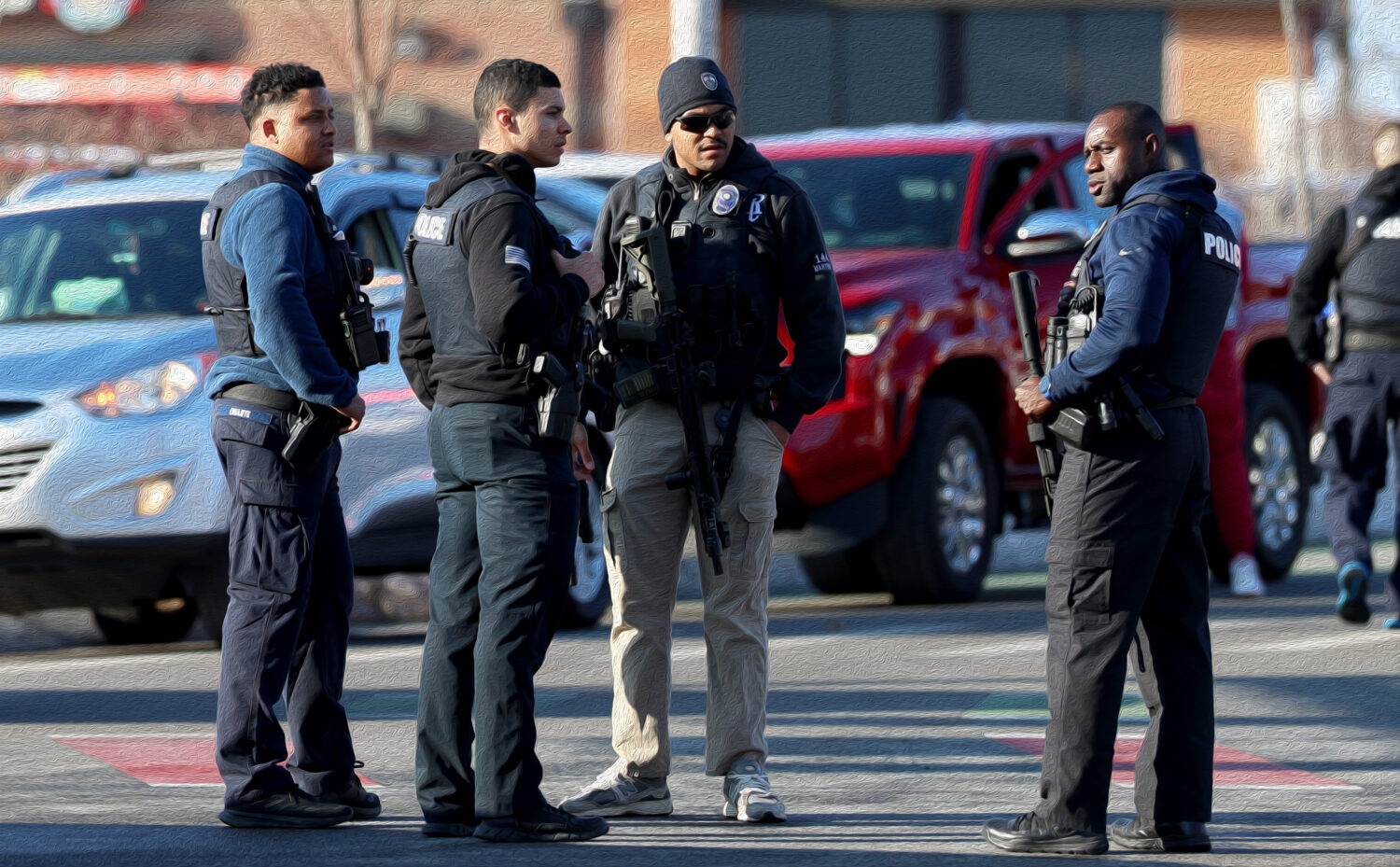 Police congregate near the Lynch Arena in Pawtucket, R.I., after a shooting occurred at the ice rin...