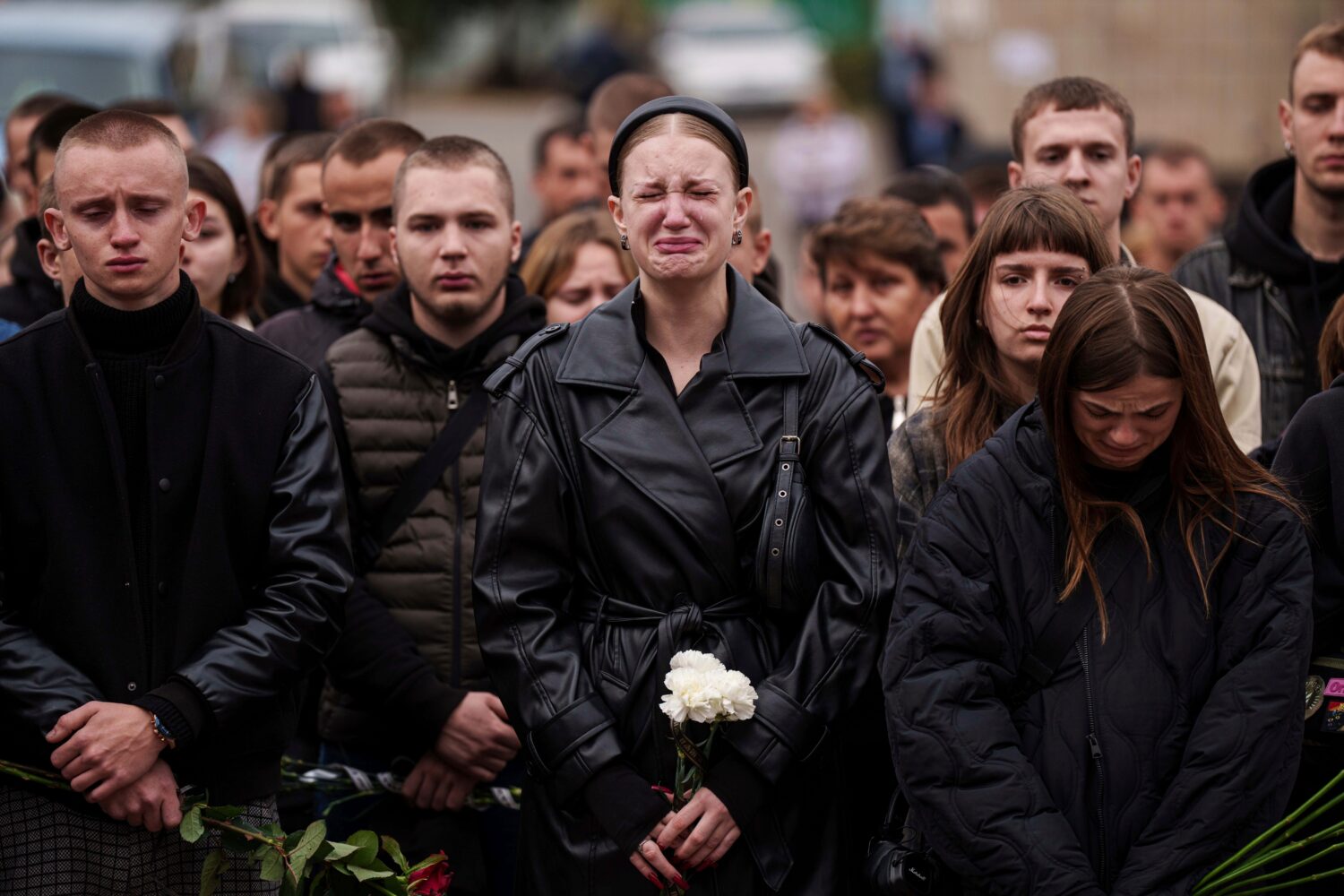 FILE - A woman cries during the funeral ceremony of Ihor Kusochek, a Ukrainian soldier of the Azov ...