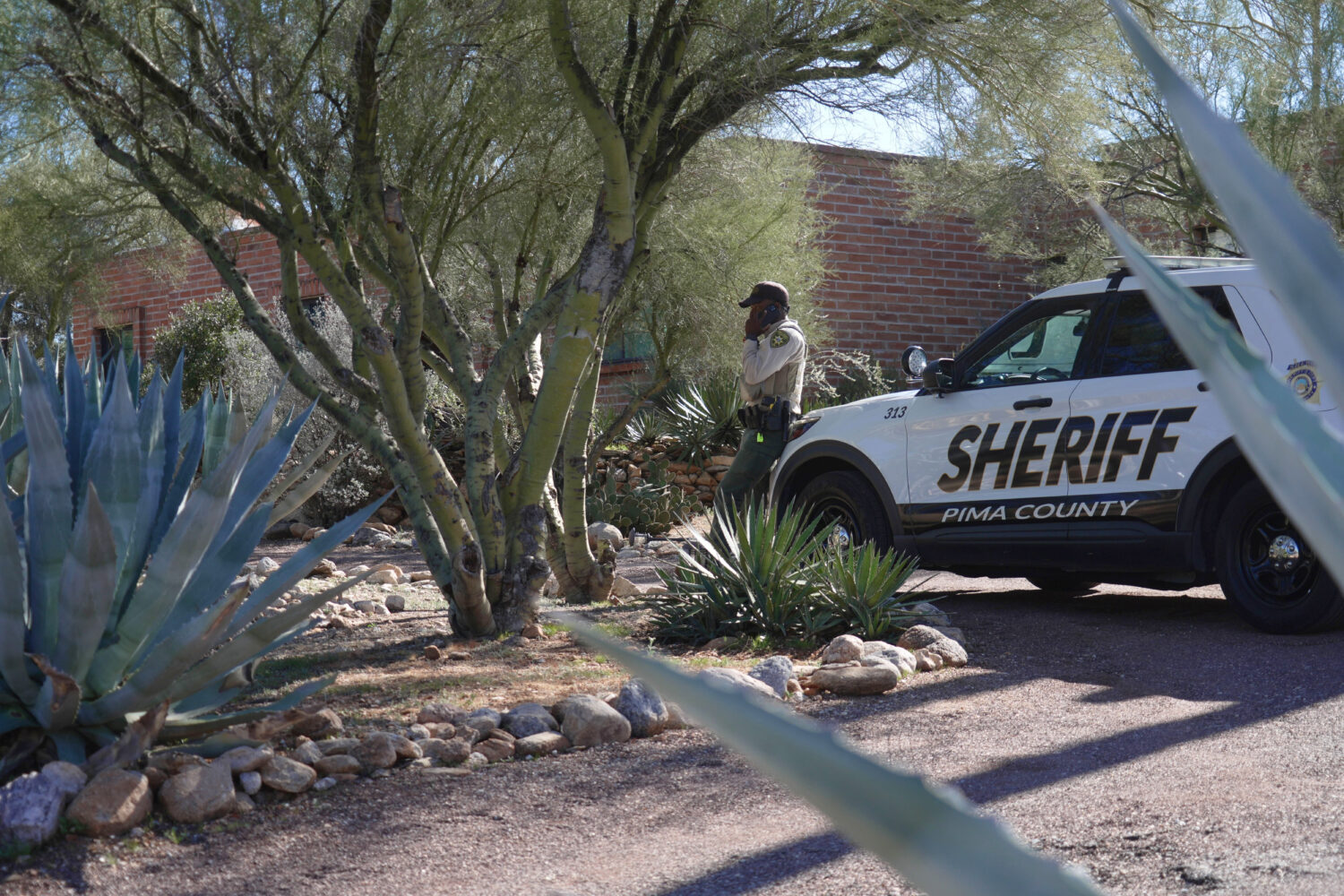 A Pima County sheriffs official stays outside of Nancy Guthrie‘s home on Saturday, Feb. 14, 2026 ...