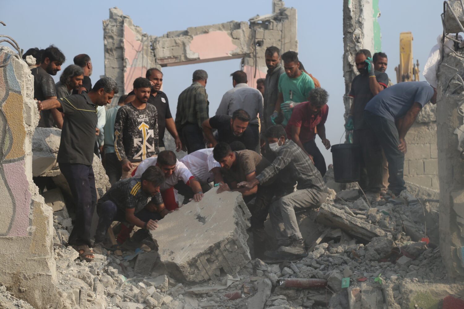 Rescue workers and residents search through the rubble in the aftermath of a strike on a girls' ele...