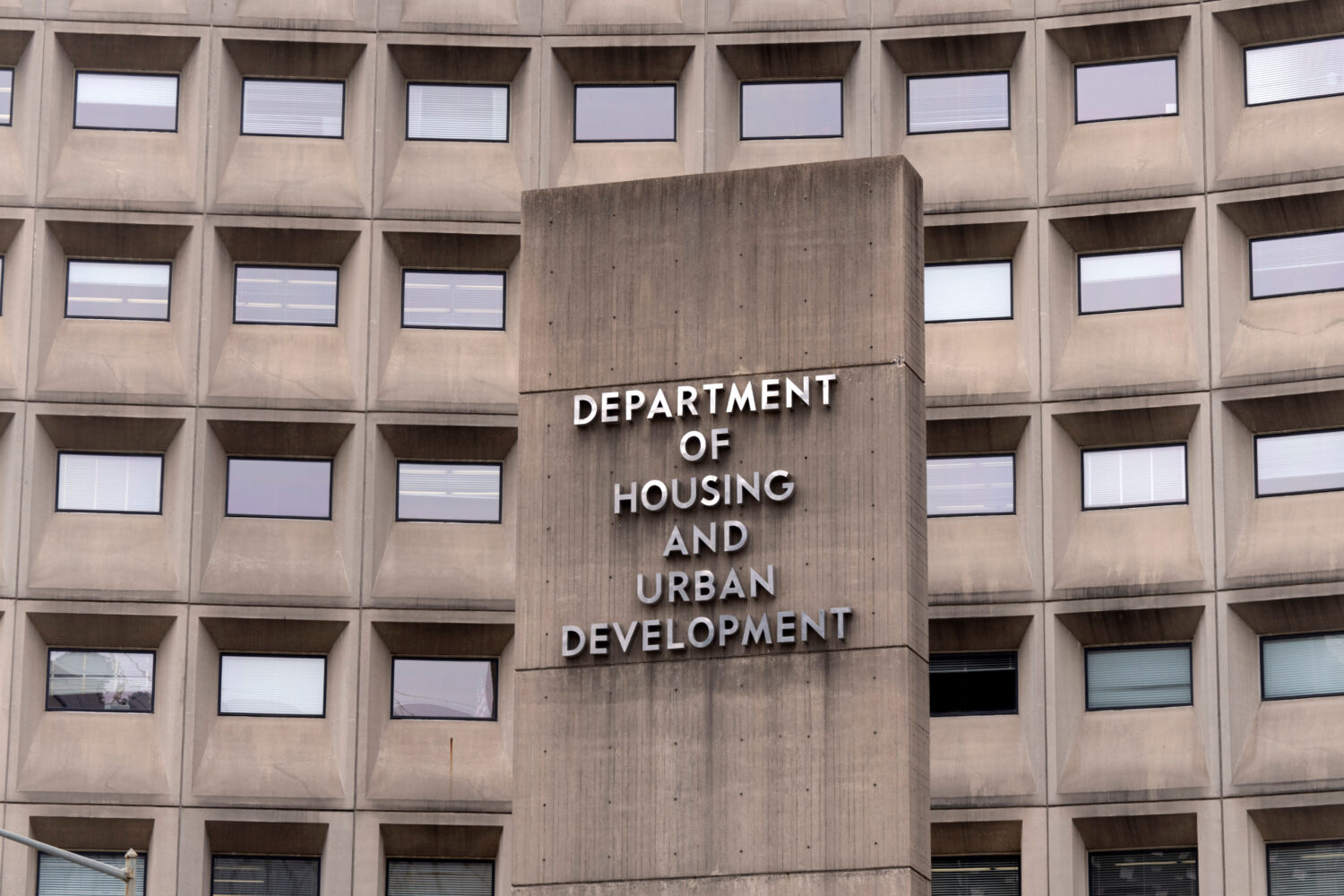 FILE - A sign for the Department of Housing and Urban Development stands outside the agency's headq...