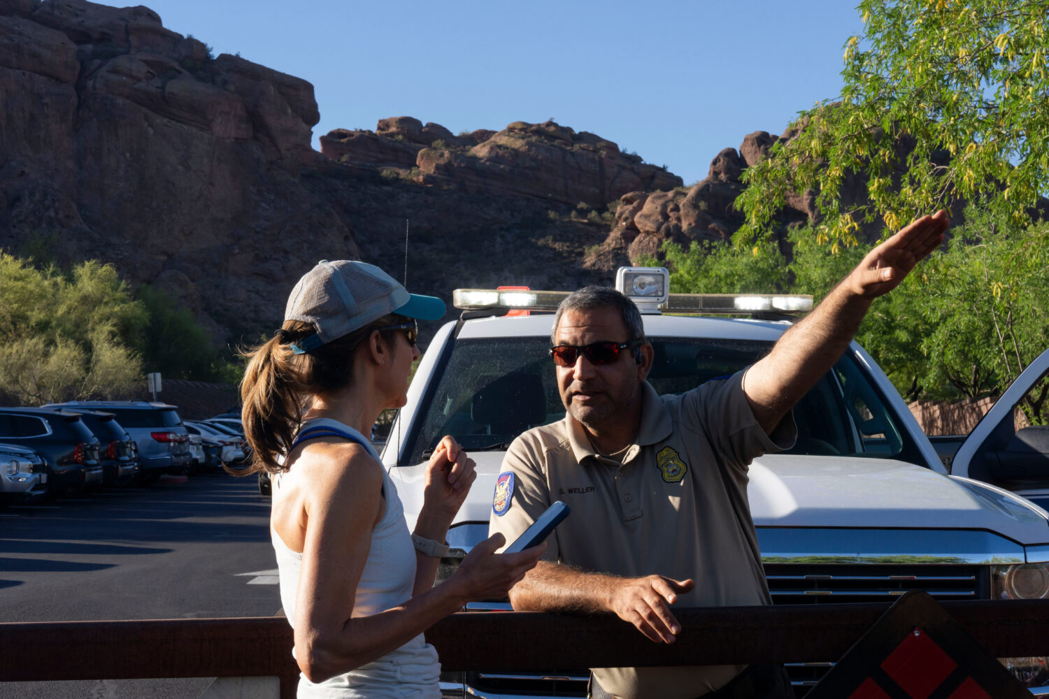 City of Phoenix Park Ranger Sam Weller, right, directs a hiker away from a trailhead closed due to ...