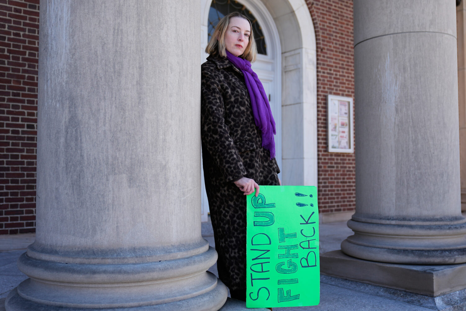 Allison Posner, an organizer for an upcoming "No Kings" protest poses for a photo on the steps of t...