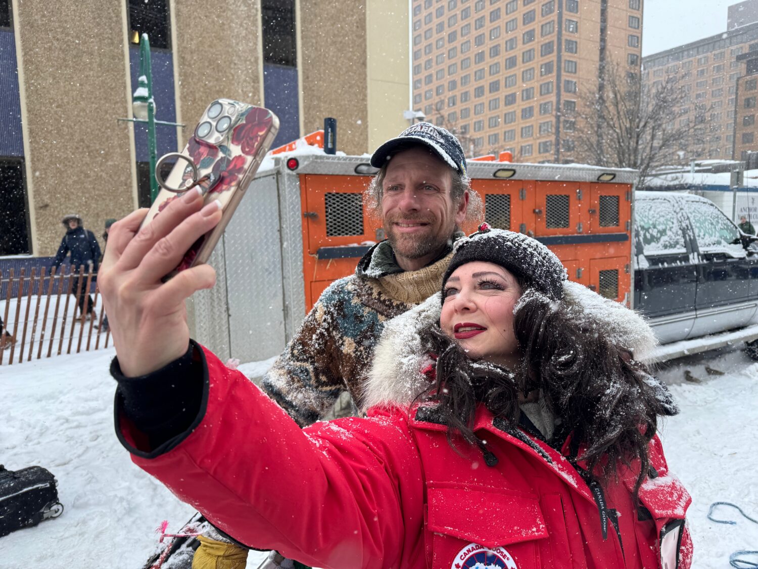 Defending Iditarod Trail Sled Dog Race champion Jessie Holmes poses for a selfie with a fan during ...
