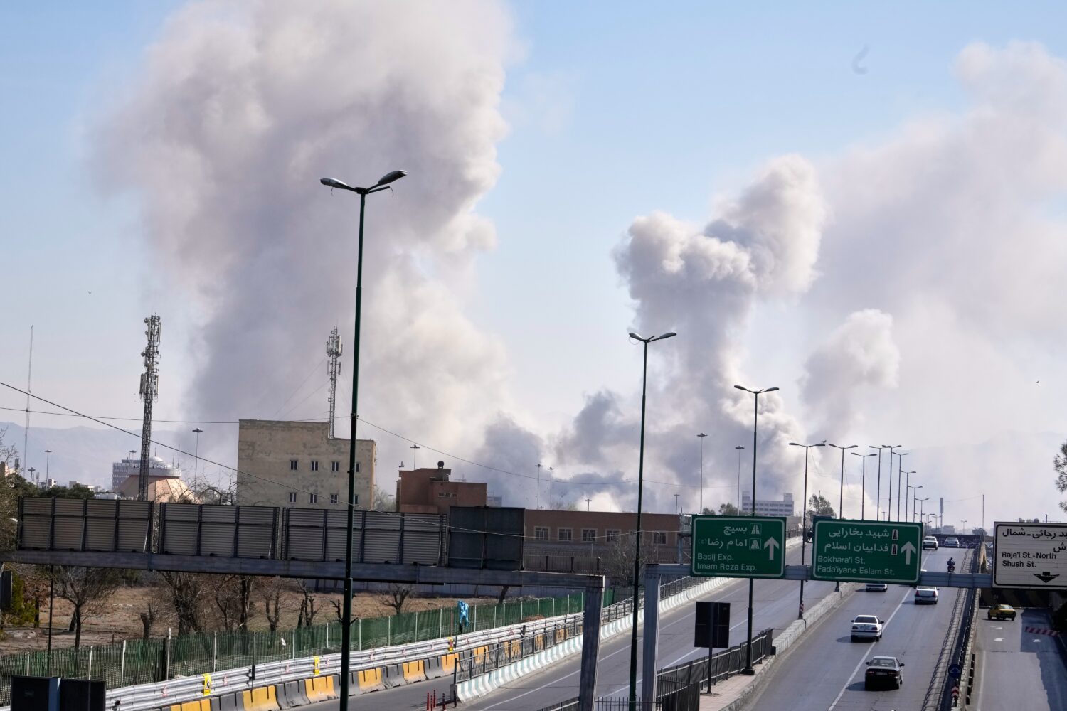 Plumes of smoke rise as strikes hit the city during the U.S.–Israeli military campaign in Tehran,...