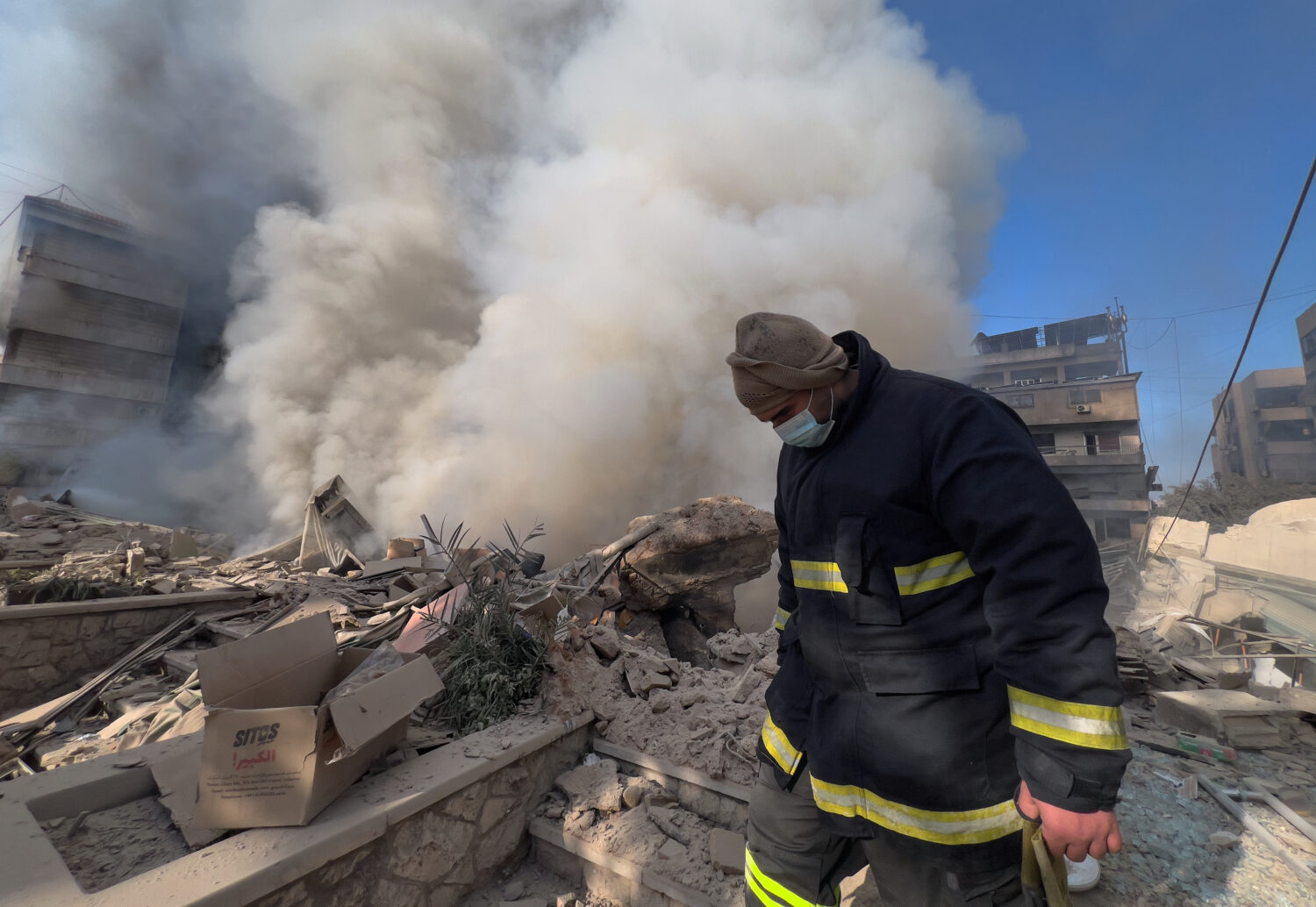 A rescue worker checks the site where several buildings were hit by Israeli airstrikes in Dahiyeh, ...