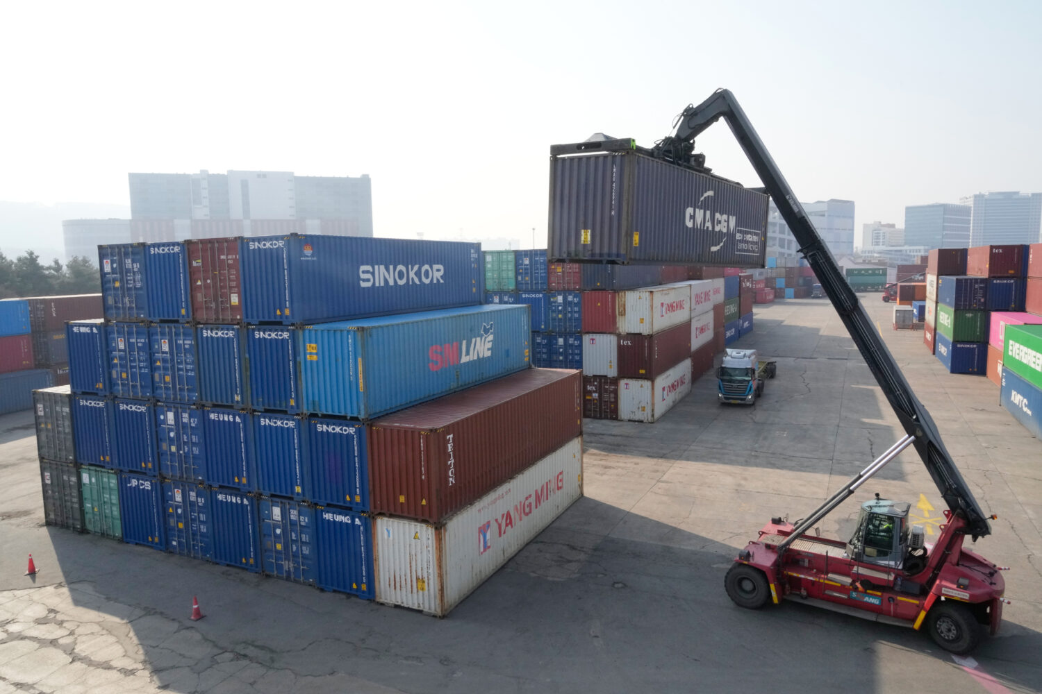 A crane unloads a container at the Uiwang ICD Terminal in Uiwang, South Korea, Thursday, March 12, ...