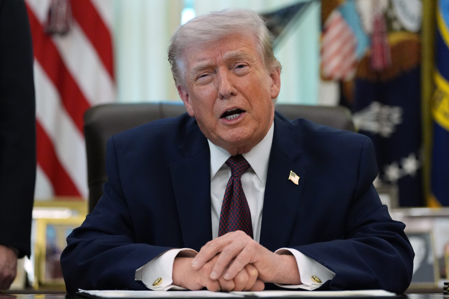 President Donald Trump speaks in the Oval Office of the White House before signing an executive ord...