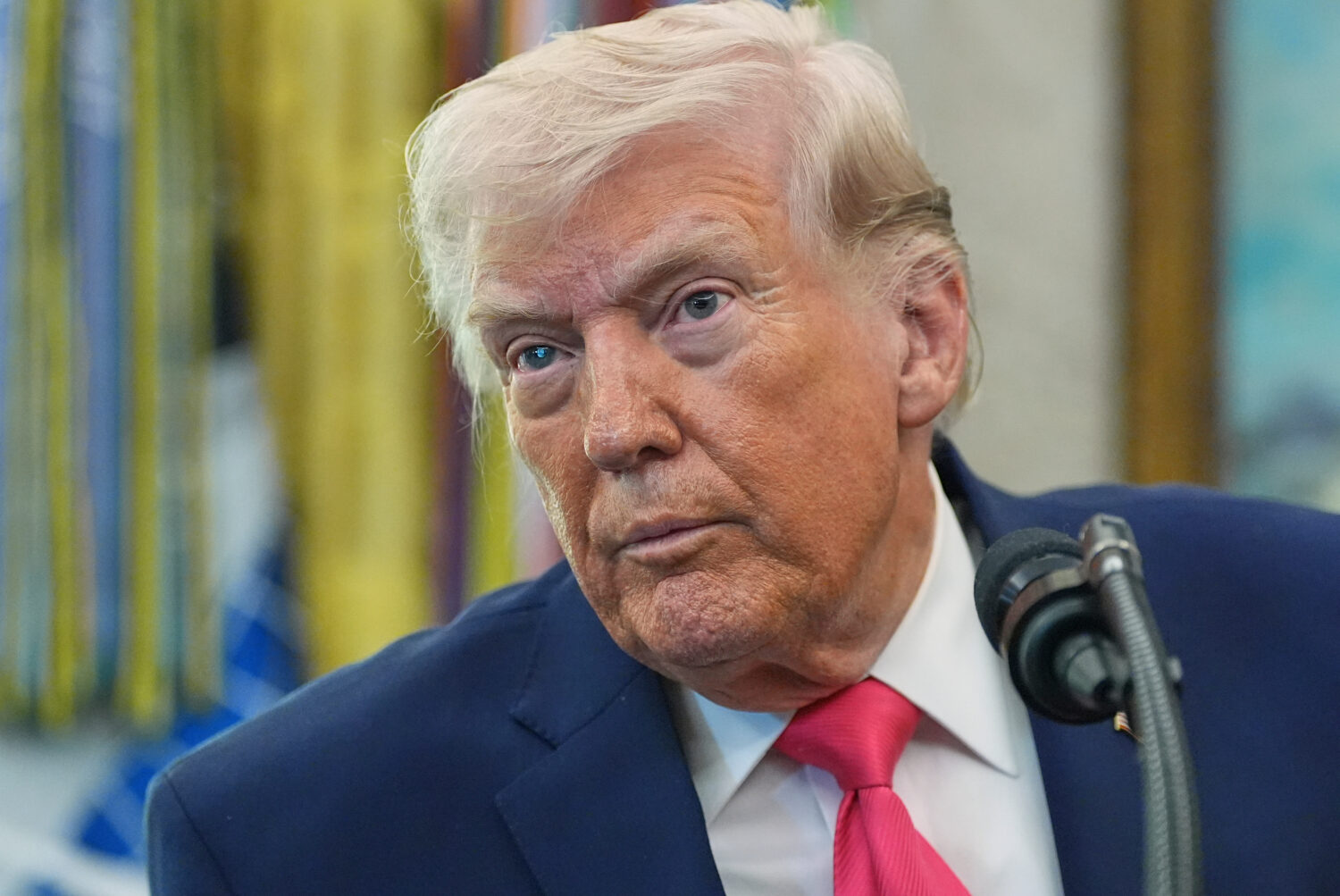 President Donald Trump listens to a reporter during the swearing in for Homeland Security Secretary...