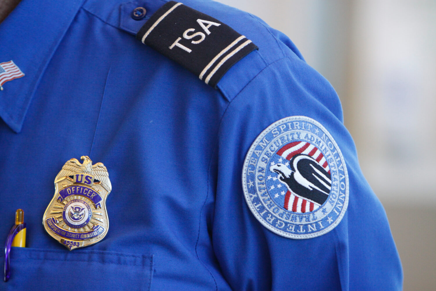 FILE -The badge and TSA logo patch are seen on the uniform of a Transportation Security Administrat...