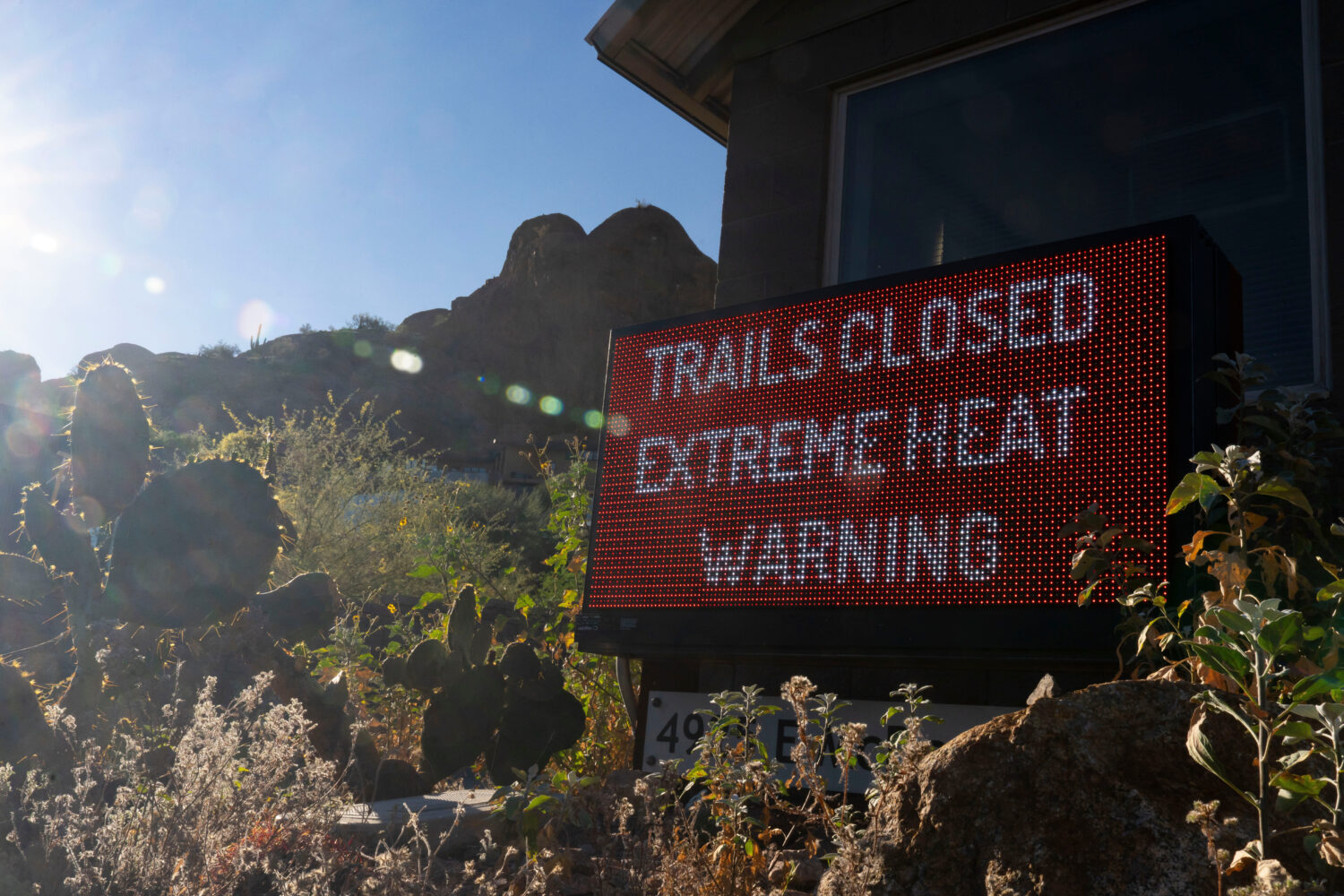 A sign warns hikers of trail closures due to extreme heat at Camelback Mountain on Thursday, March ...