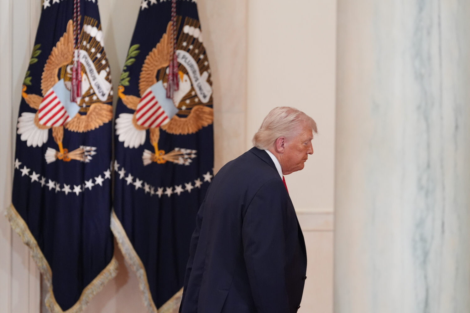 President Donald Trump departs after speaking about the Iran war from the Cross Hall of the White H...