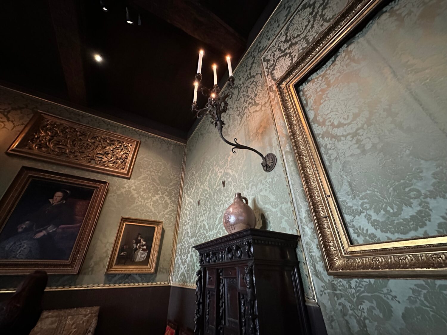 An empty frame hangs on patterned green walls in the Dutch Room at the Isabella Stewart Gardner Mus...