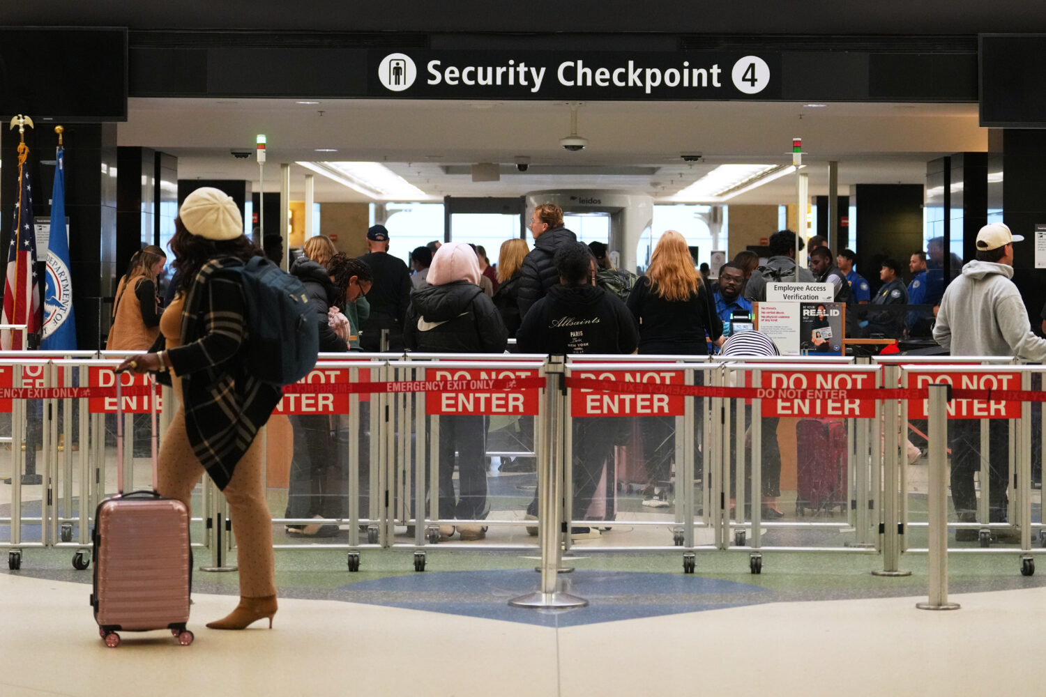 FILE - A traveler walks by a security checkpoint at Seattle-Tacoma International Airport, Nov. 6, 2...