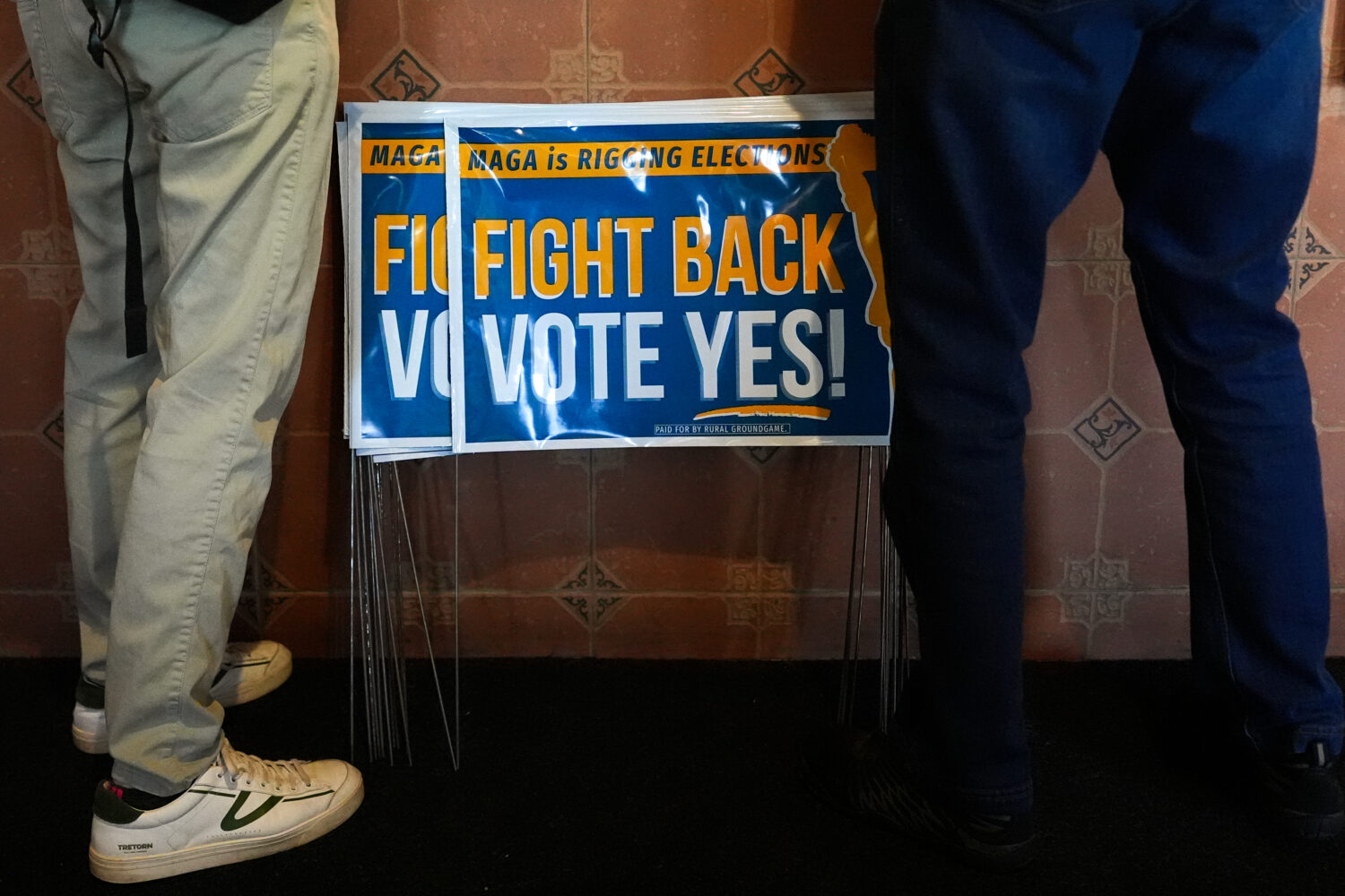 Signs in support of the Virginia redistricting referendum are seen as Jen Strozier and Doug Mock, m...