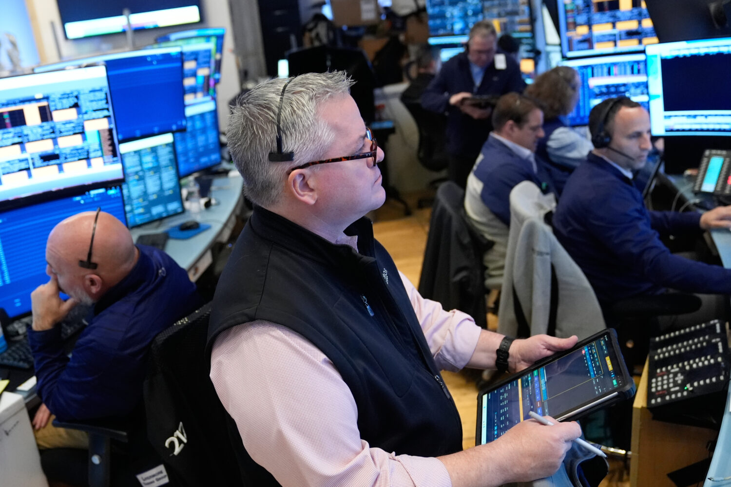 People work on the floor at the New York Stock Exchange in New York, Monday, April 13, 2026. (AP Ph...