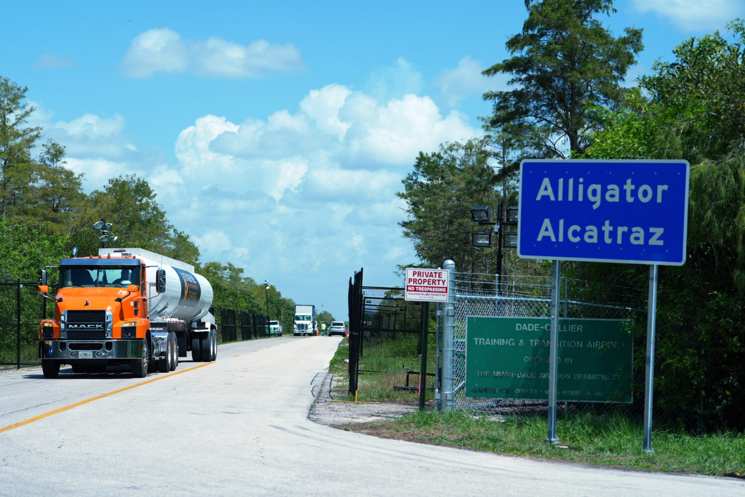 FILE - Trucks come and go from the "Alligator Alcatraz" immigration detention center in the Florida...