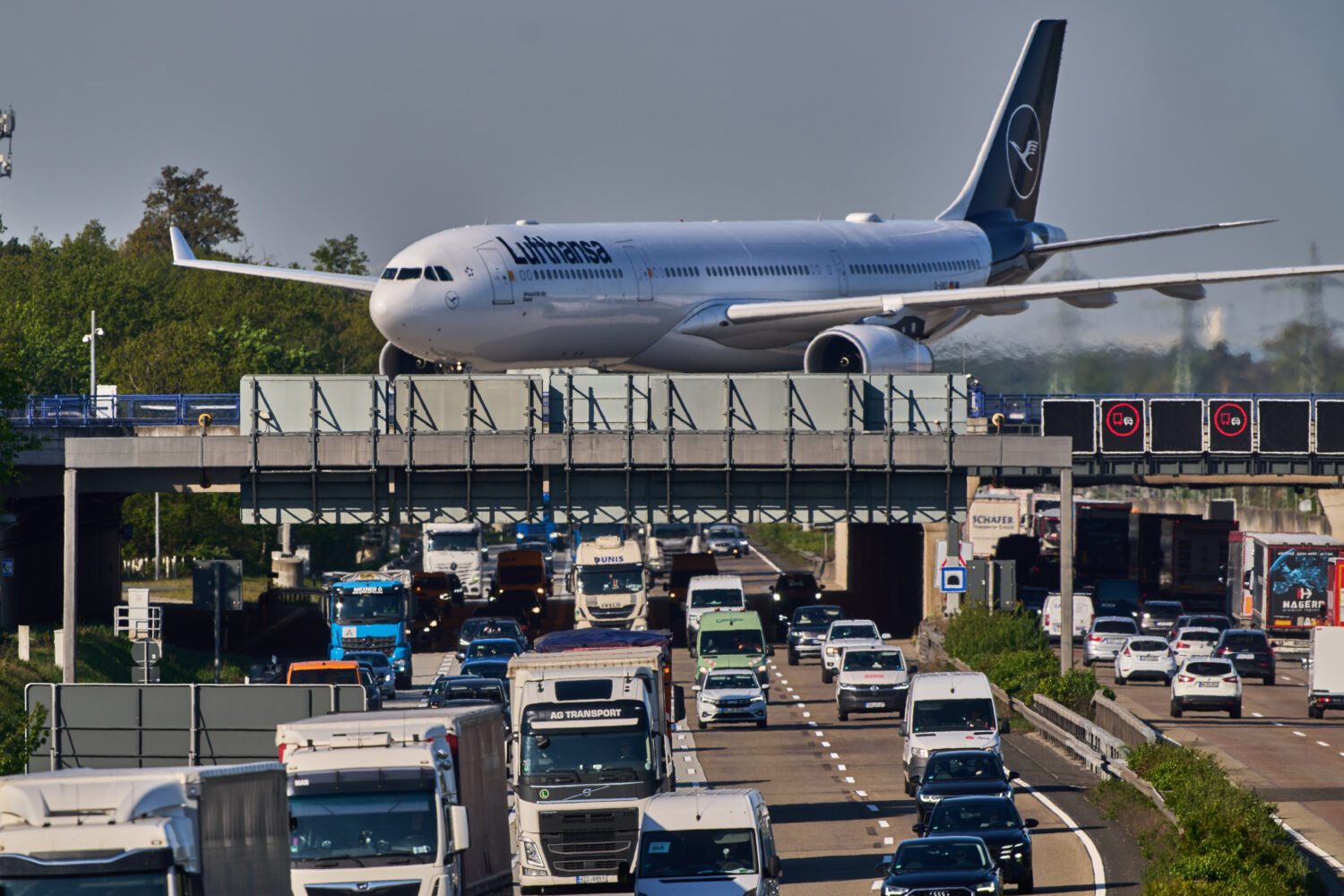 A Lufthansa aircraft rolls on a bridge over a highway at the airport in Frankfurt, Germany, Wednesd...