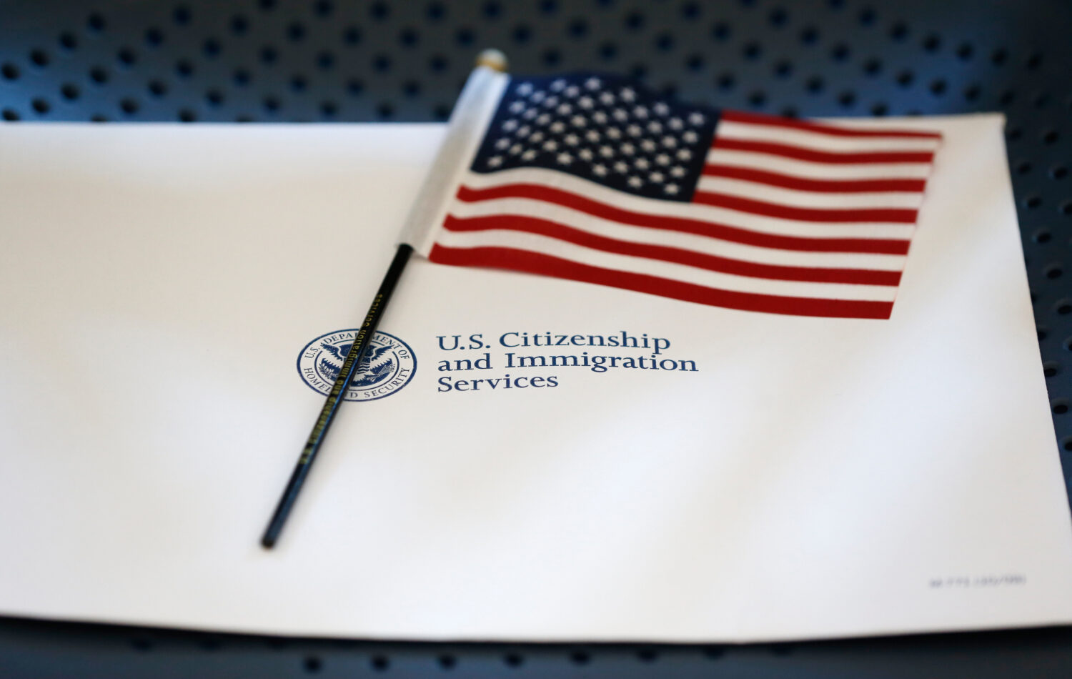 FILE - An information packet and an American flag are placed on a chair at the U.S. Citizenship and...