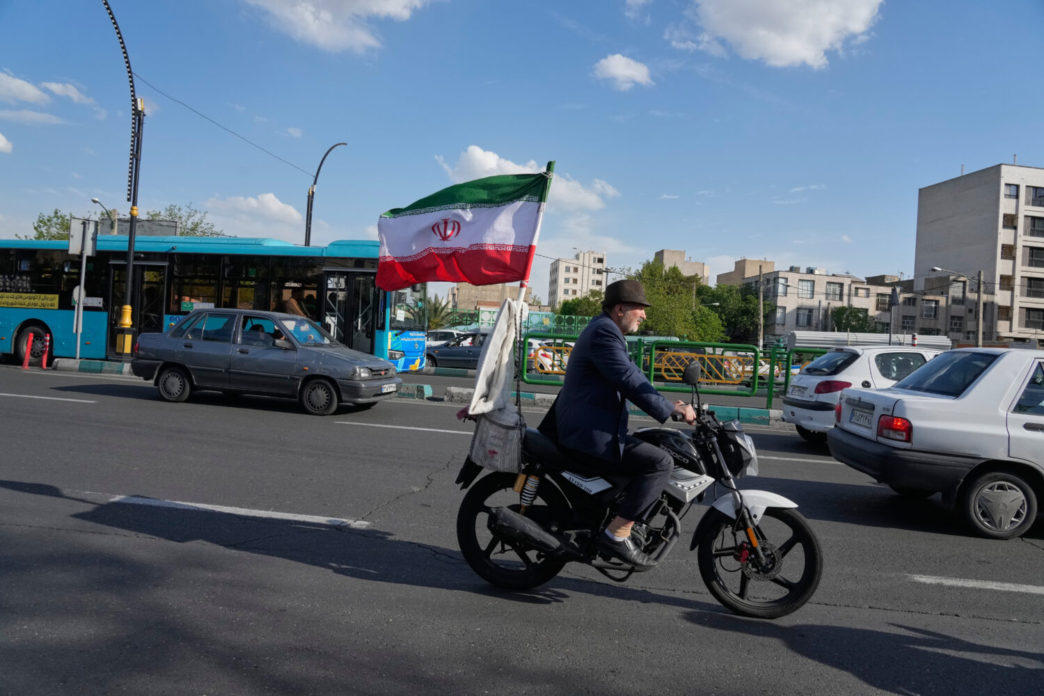 A man rides his motorbike that is adorned with an Iranian national flag, in southern Tehran, Iran, ...