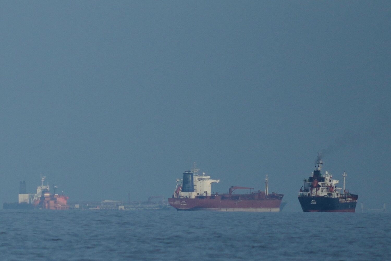 FILE - Oil tankers and cargo ships line up in the Strait of Hormuz as seen from Khor Fakkan, United...