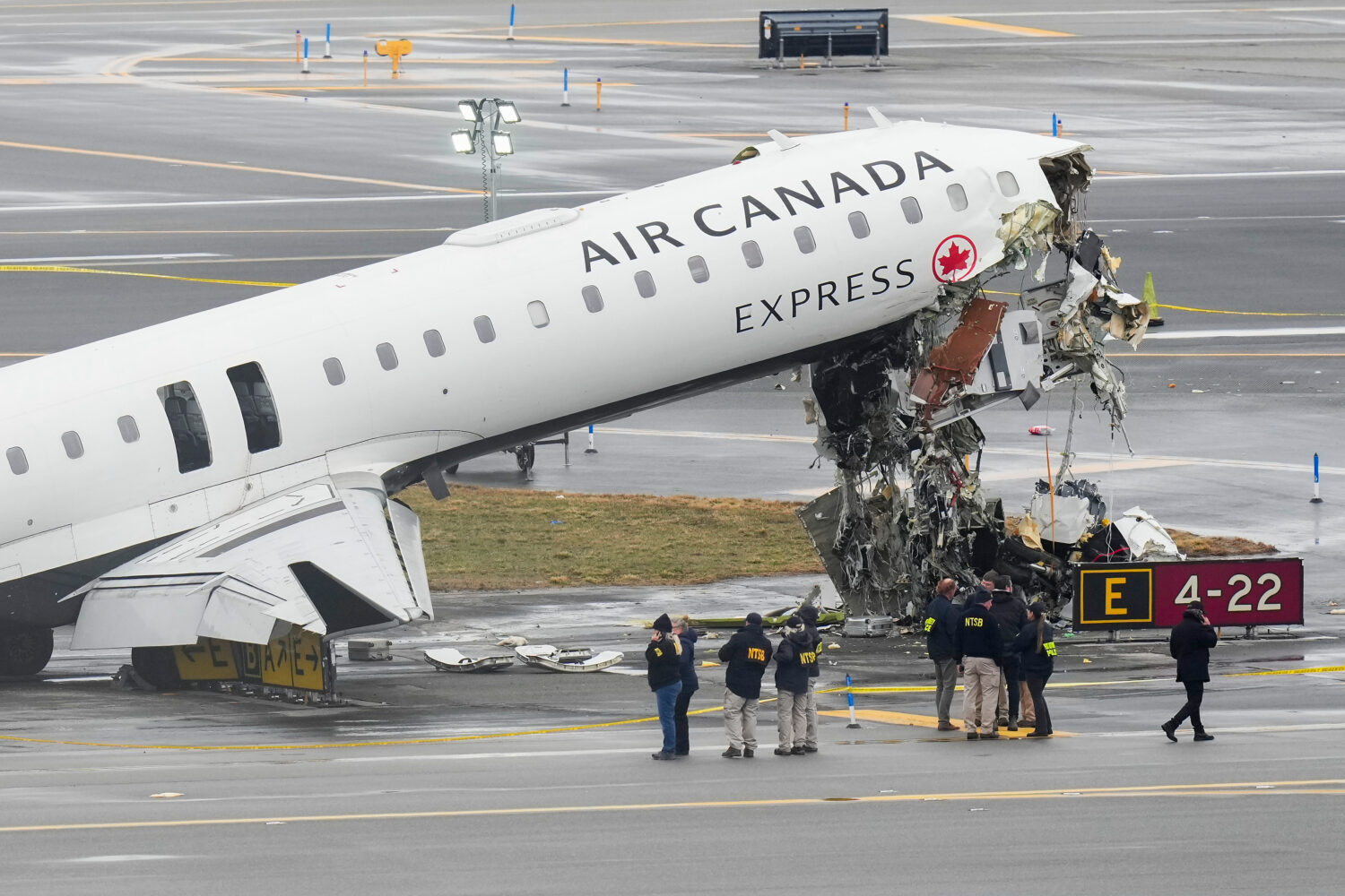 FILE - Officials with the National Transportation Safety Board investigate the site, March 23, 2026...