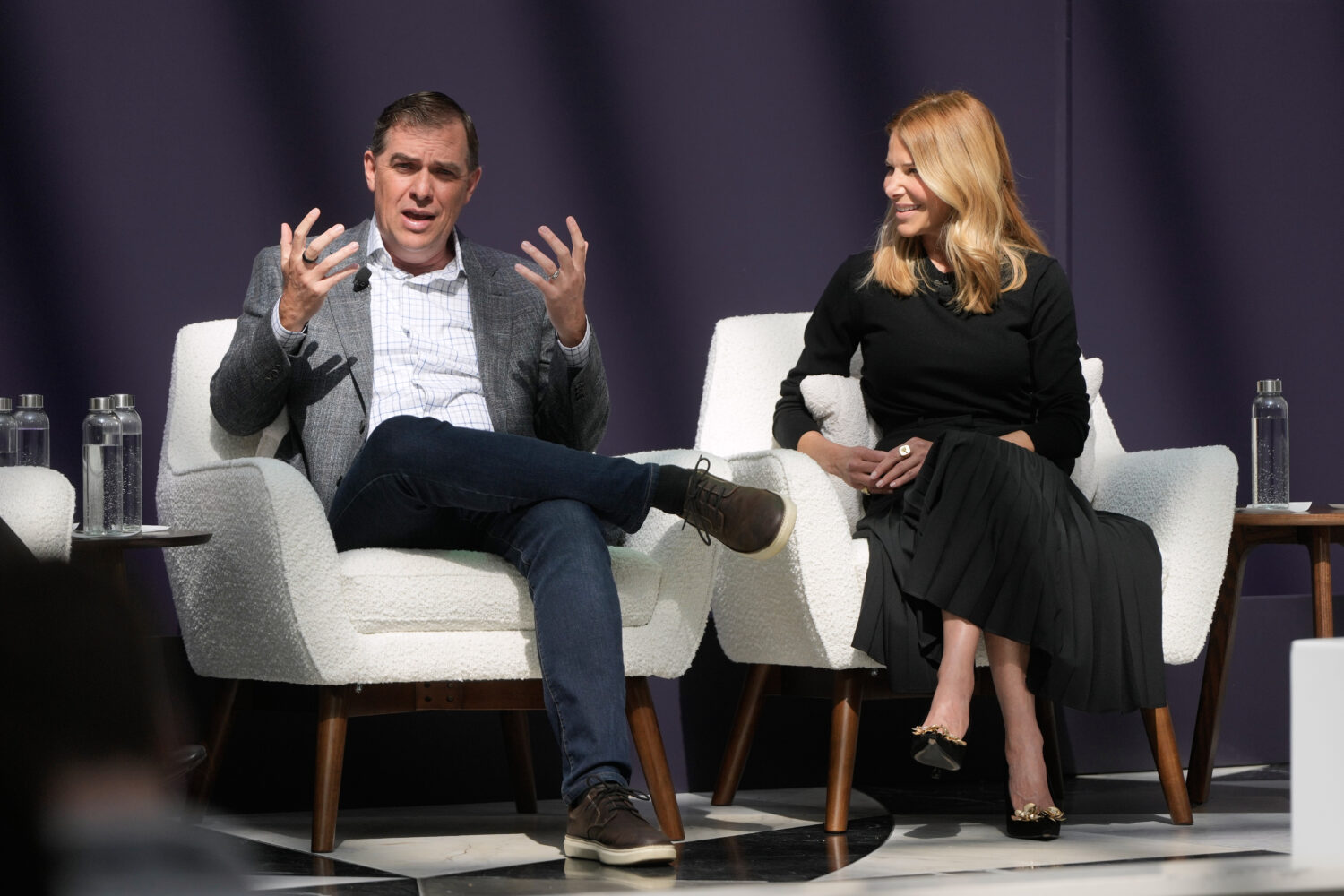 Matt Garman, CEO of AWS, left, speaks next to Denise Dresser, chief revenue officer of OpenAI, at a...