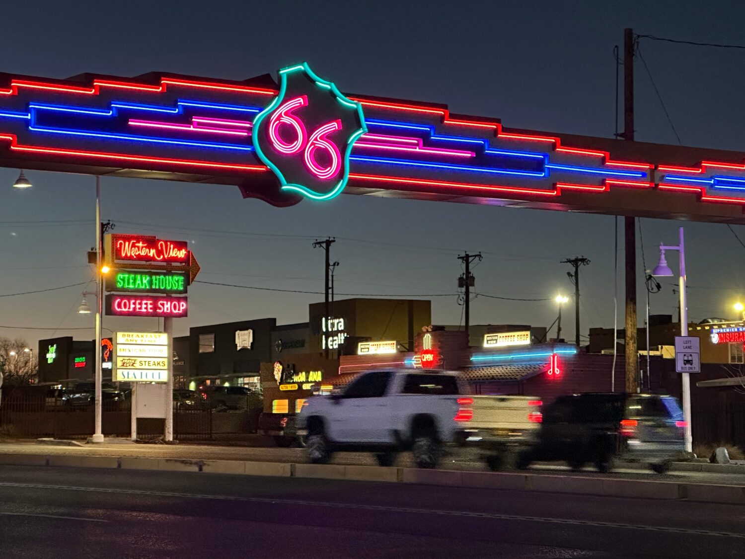 Traffic passes under a neon Route 66 sign on the west end of Albuquerque, New Mexico, Friday, Jan. ...