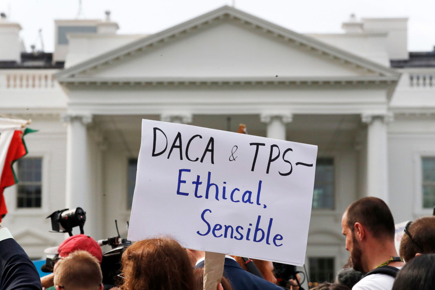A person holds up a sign in support of the Deferred Action for Childhood Arrivals, known as DACA, a...