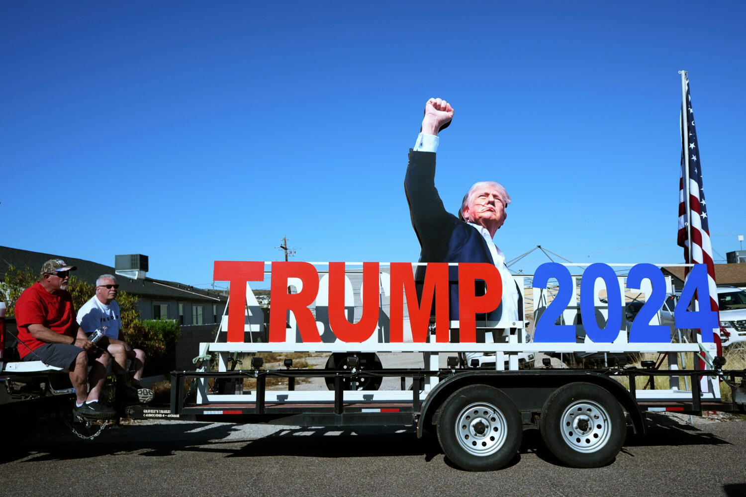 President Donald Trump supporters sit on a tailgate near the venue where the president is scheduled...
