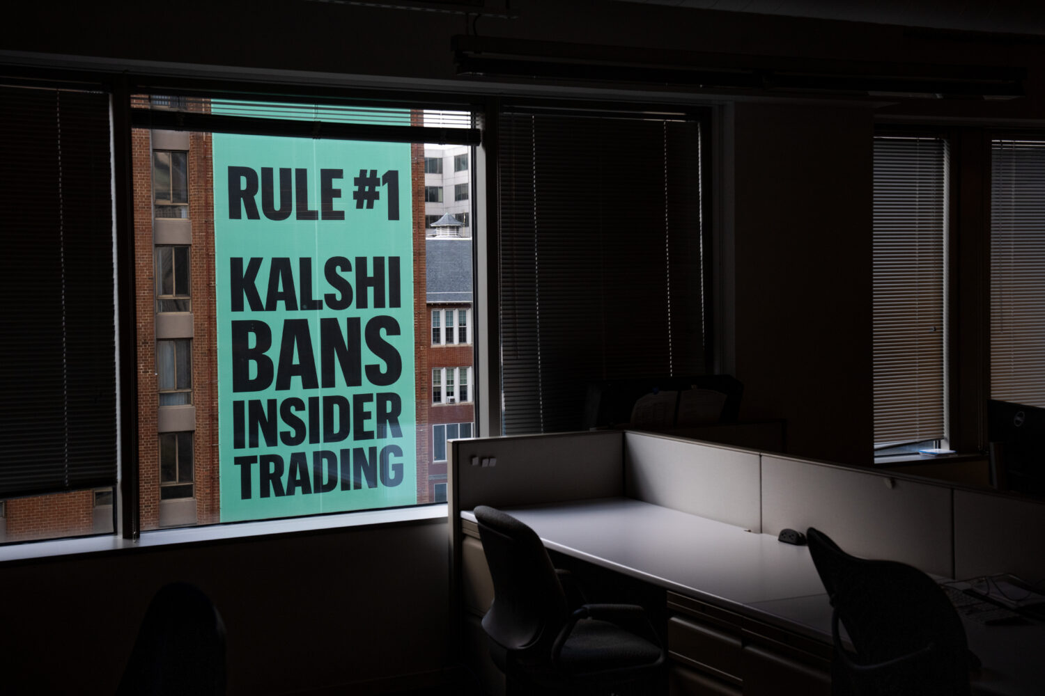 FILE - A banner for the prediction market platform Kalshi hangs from a building in Washington, Wedn...