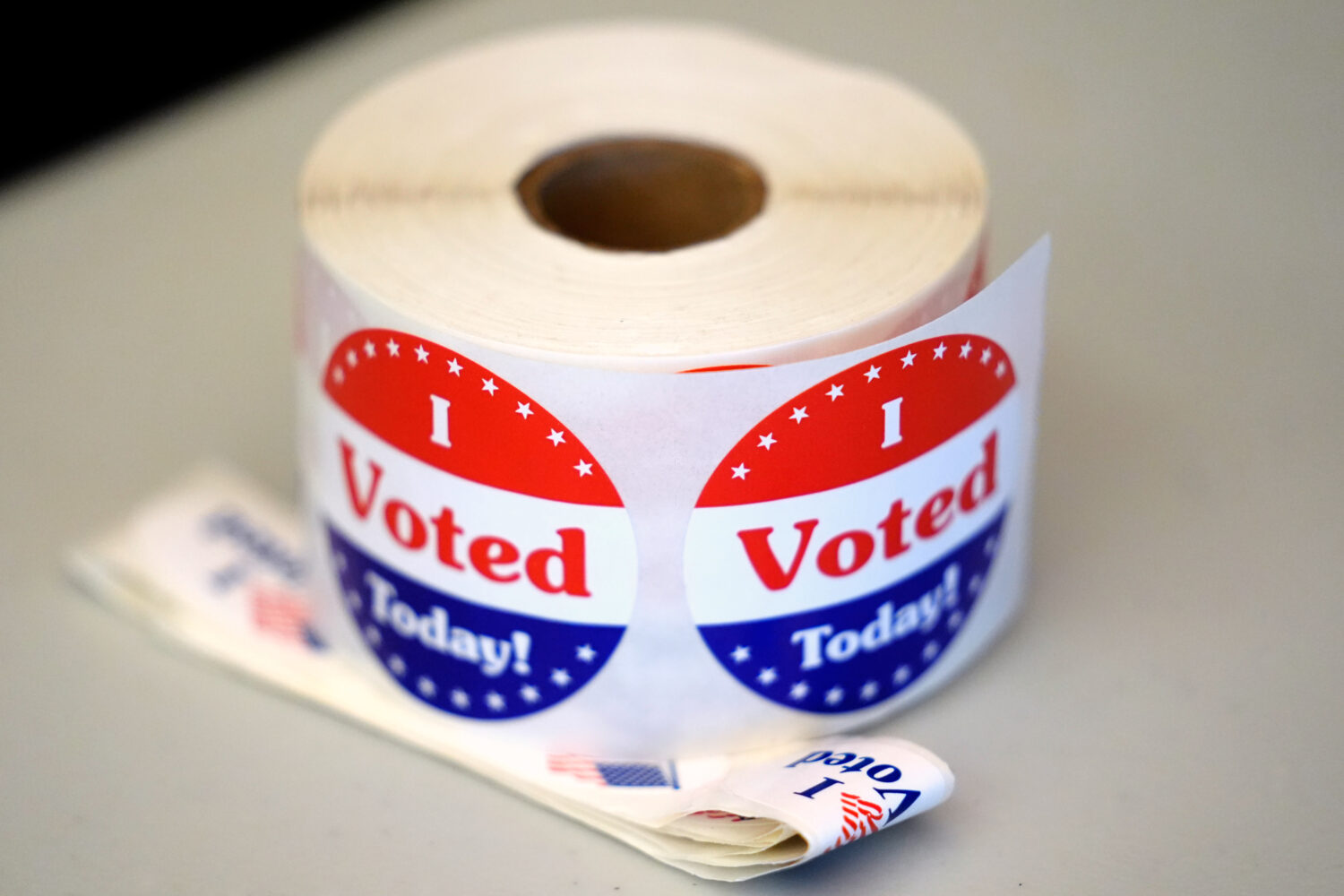FILE - A spool of stickers rests on a table at a polling station during Massachusetts state primary...