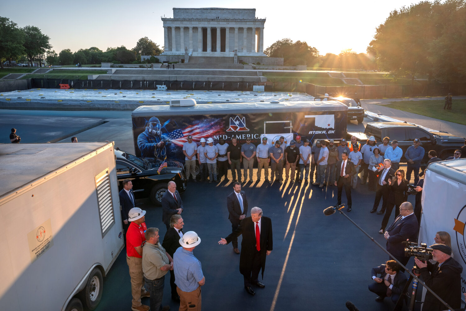 President Donald Trump talks as he visits the Lincoln Memorial Reflecting Pool to see the new blue ...