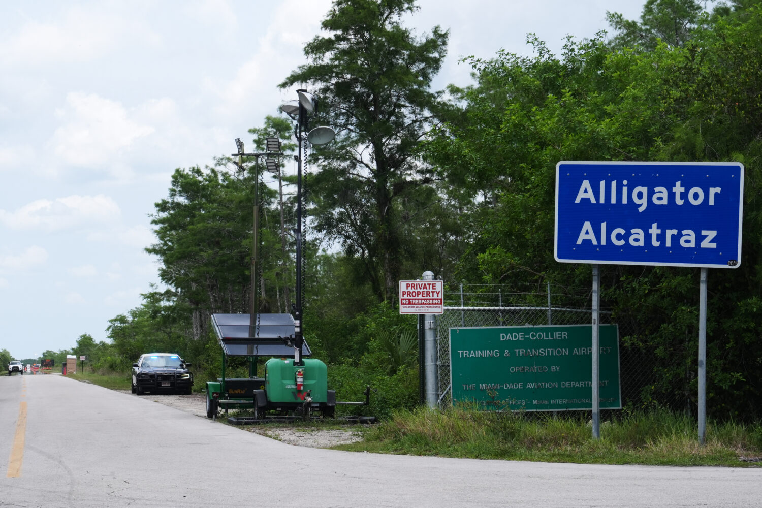 A Florida Highway Patrol car guards the entrance to the "Alligator Alcatraz" detention center Monda...