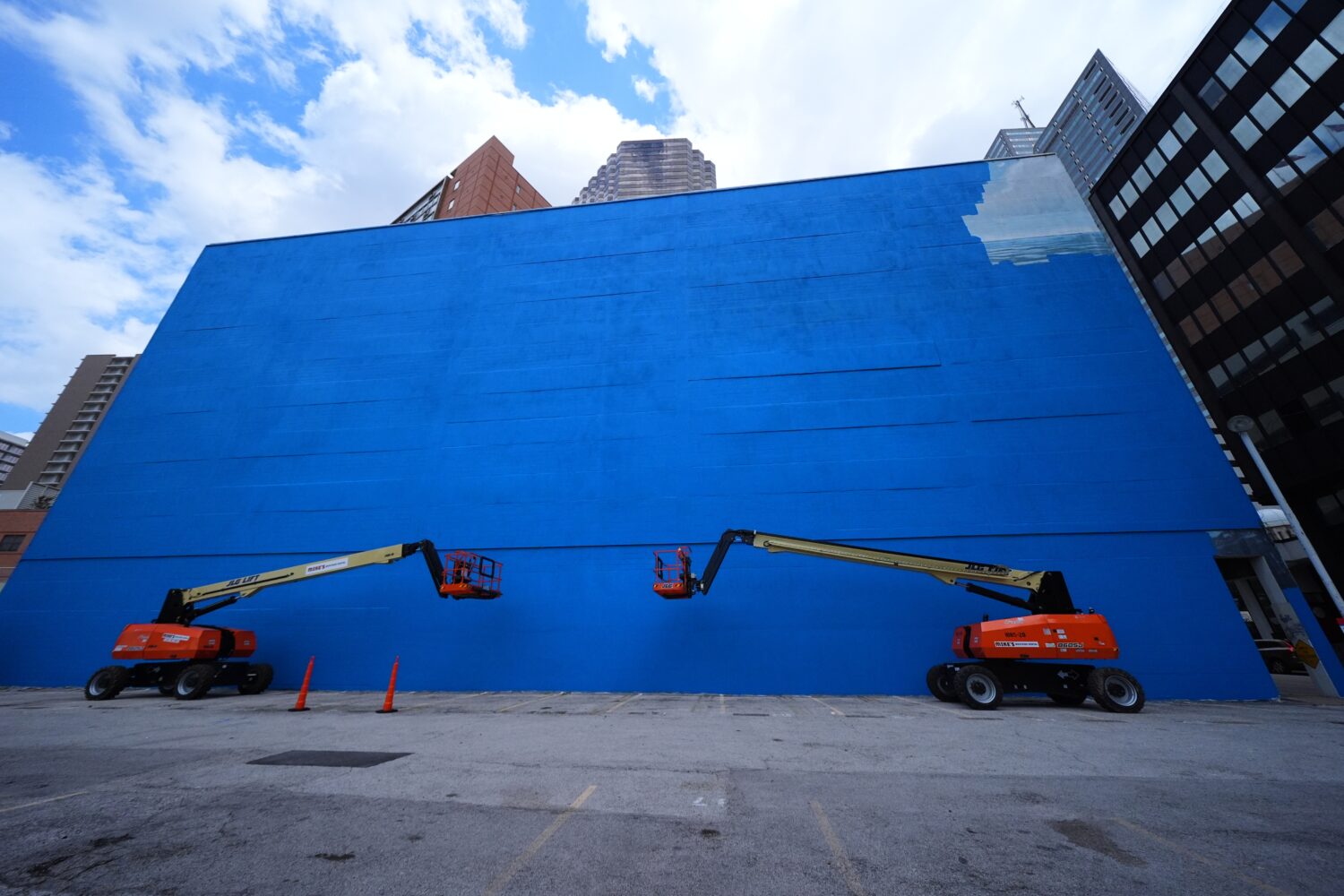A mural, known as the "Whaling Wall 82," created by artist Wyland, is partially visible as it is pa...