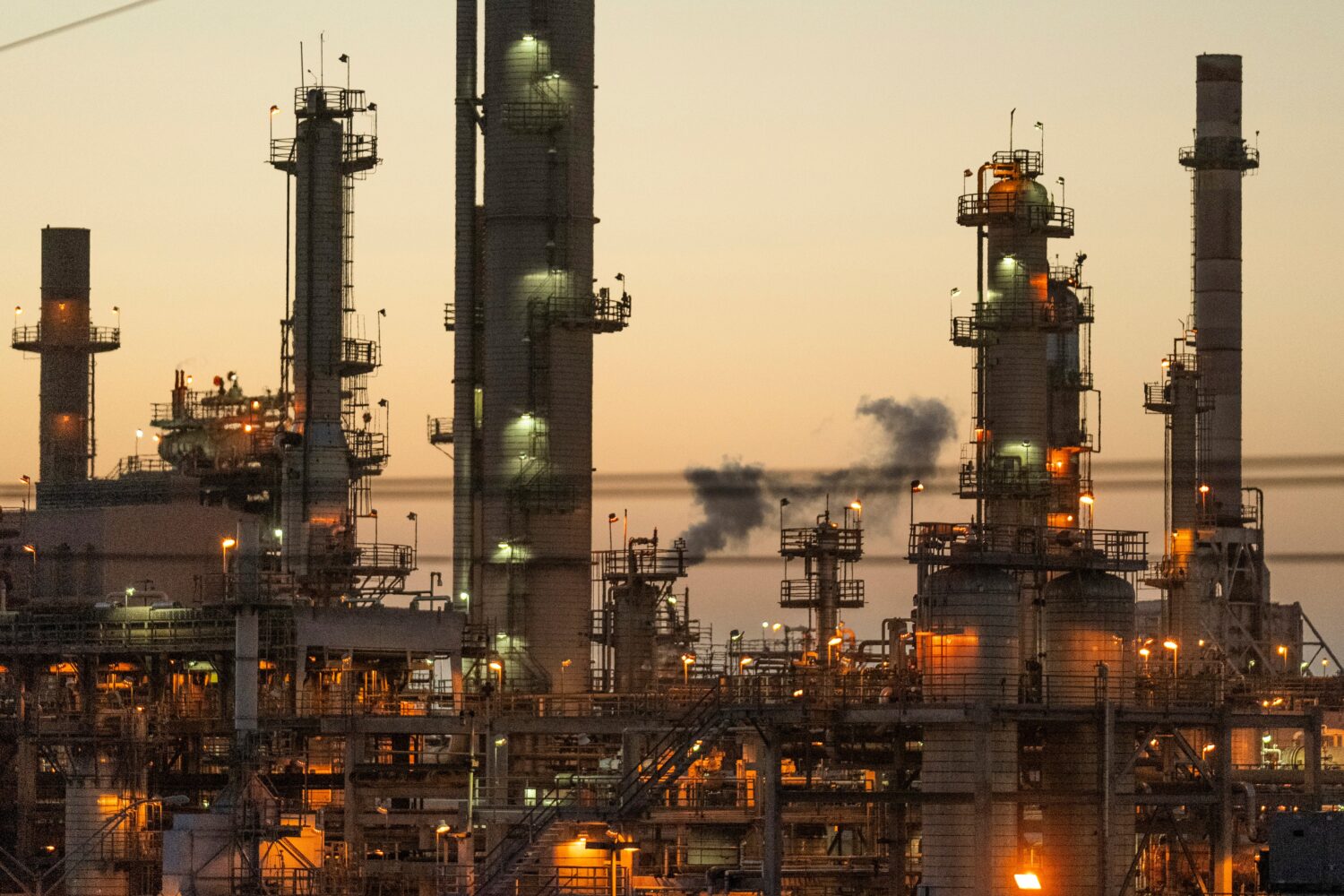 FILE - Lights illuminate an oil refinery in Carson, Calif., May 29, 2024. (AP Photo/Damian Dovargan...